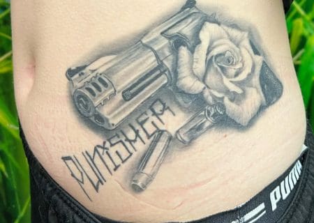 realistic black & grey revolver/rose romantic tattoo